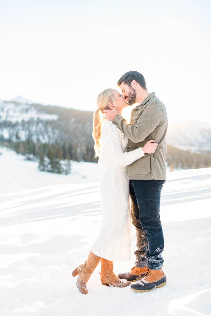 Engagement photo taken during sunset on a snowy hill in Vail, Colorado.